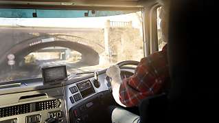 Truck driver using in-cab navigation with GPS truck tracking