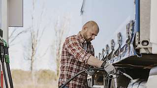 man fueling truck