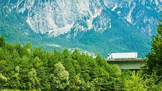 Truck driving through green landscape