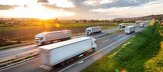 trucks on the road sunset