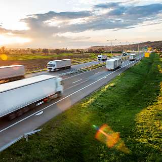 trucks on the road sunset