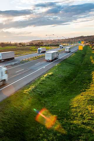 trucks on the road sunset