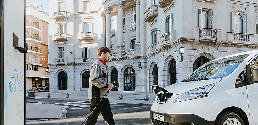 A driver prepares to charge an EV battery
