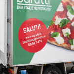 A Buratti delivery worker loads a Buratti truck
