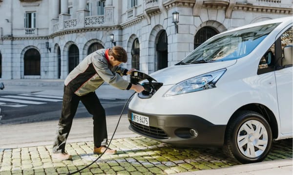 Driver charging an EV car